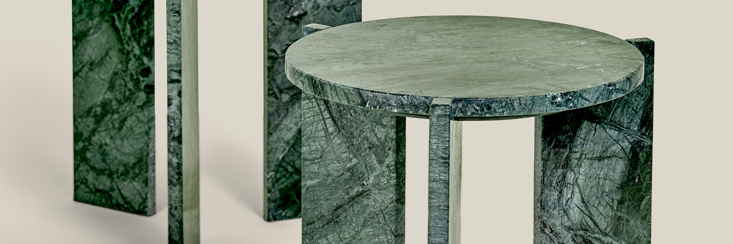 A close-up of Minerva side table in Verde Guatemala marble.