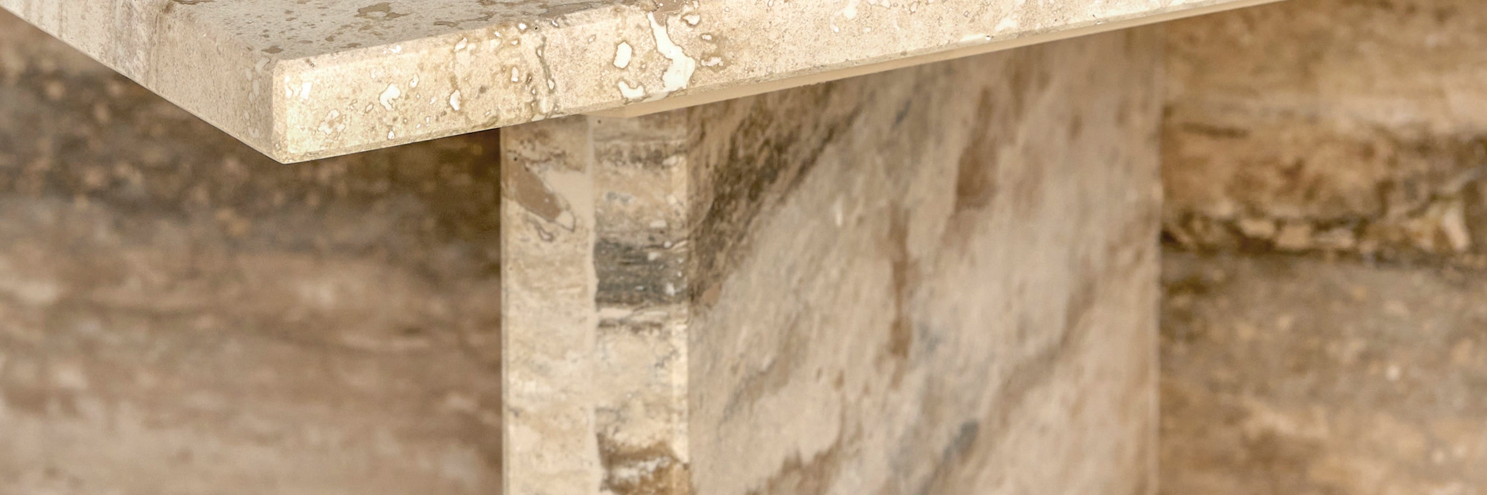 A close-up detail of an Elba silver Travertine side table.