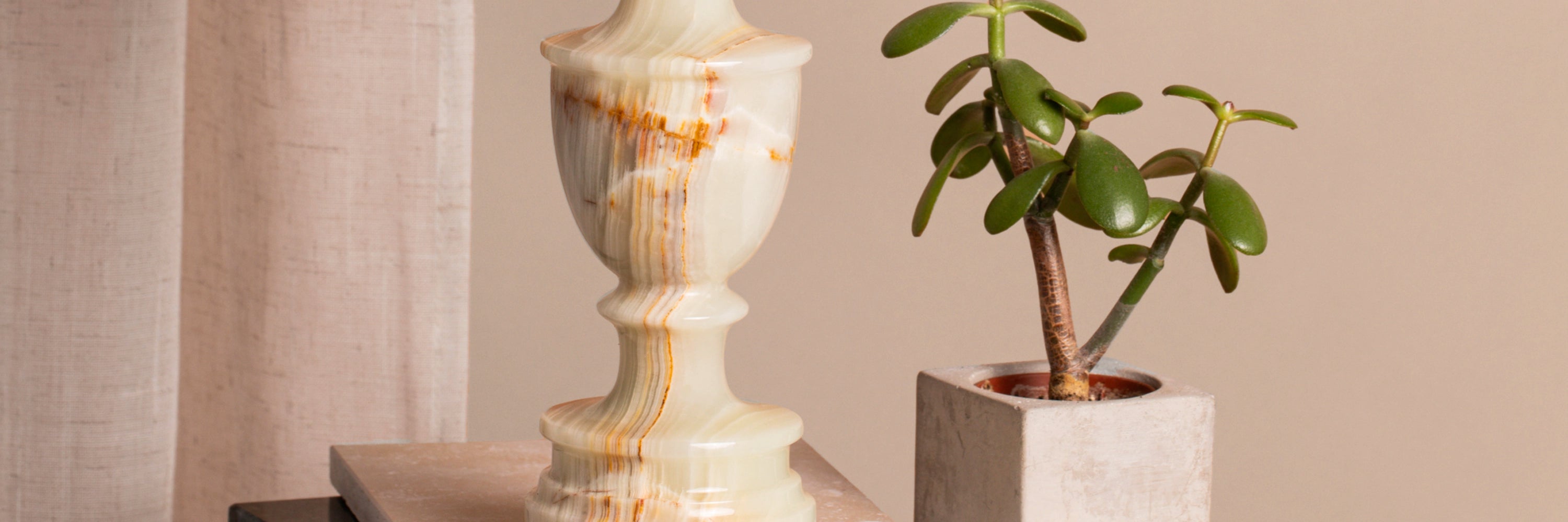 A close-up of a vintage mid-century pale green alabaster table lamp.