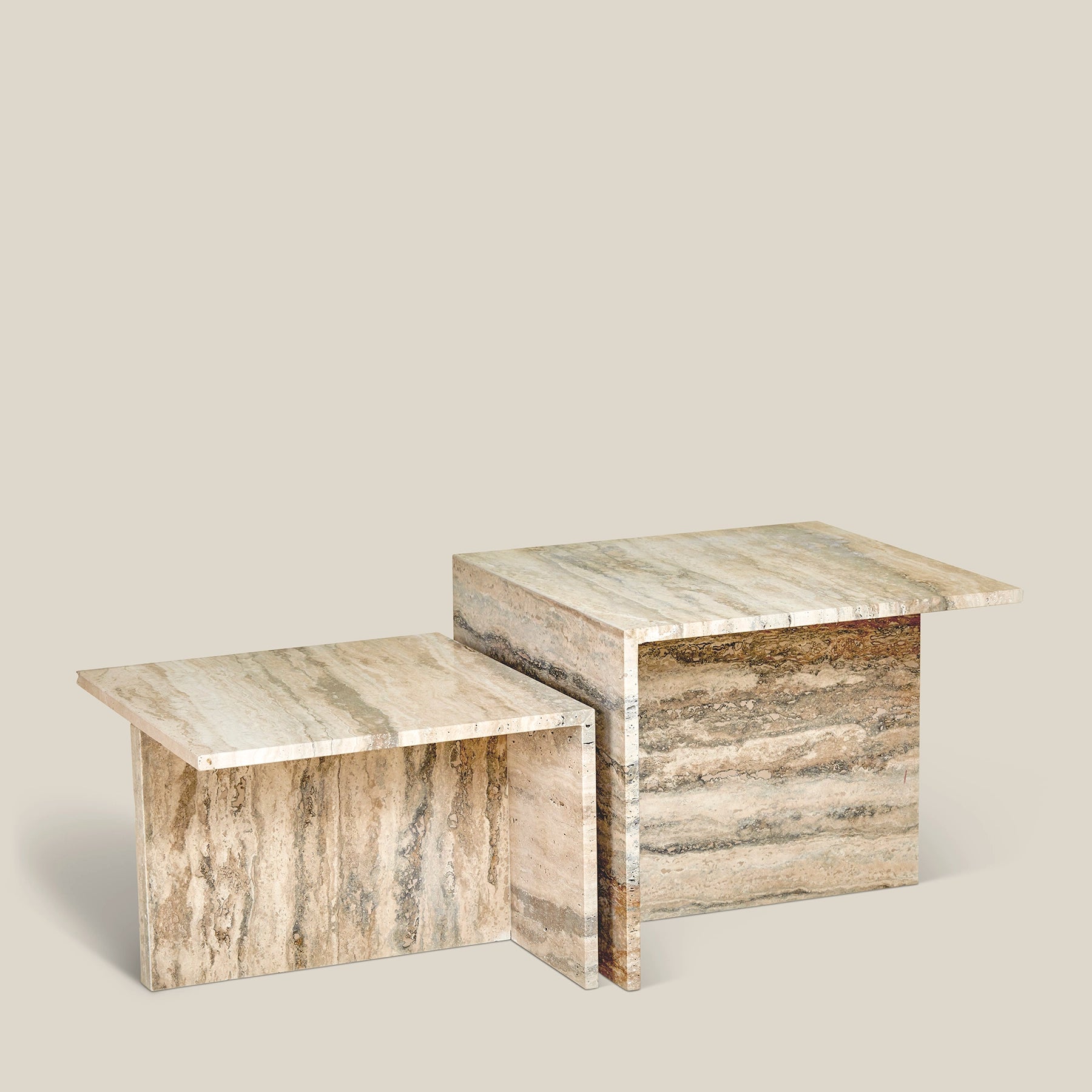 Two modern Elba side tables made from Travertine Romano marble.