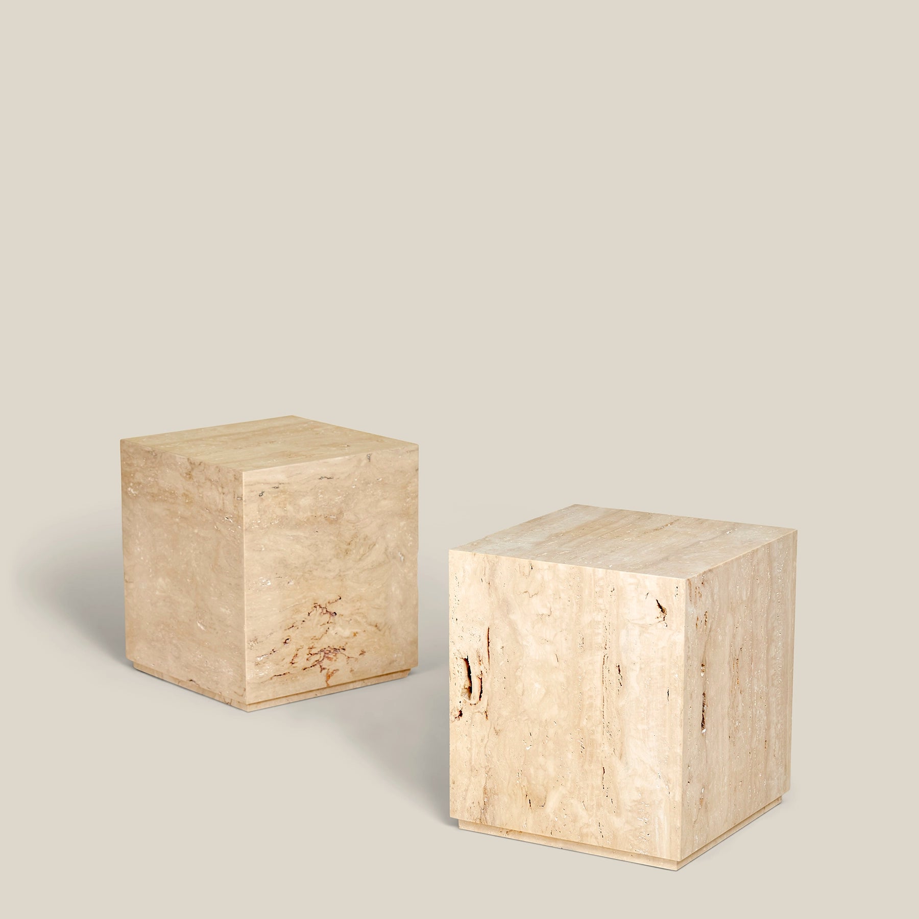 Two Fia plinth side tables made from Travertine Romano marble.