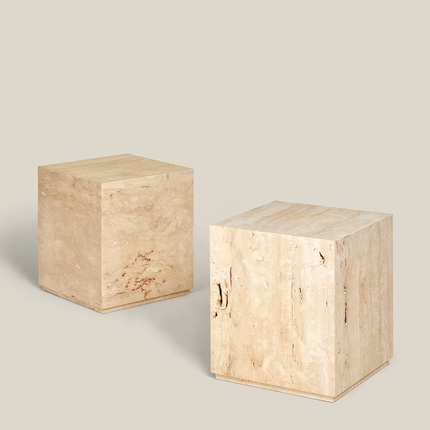 Two plinth side tables made from Travertine Romano marble.