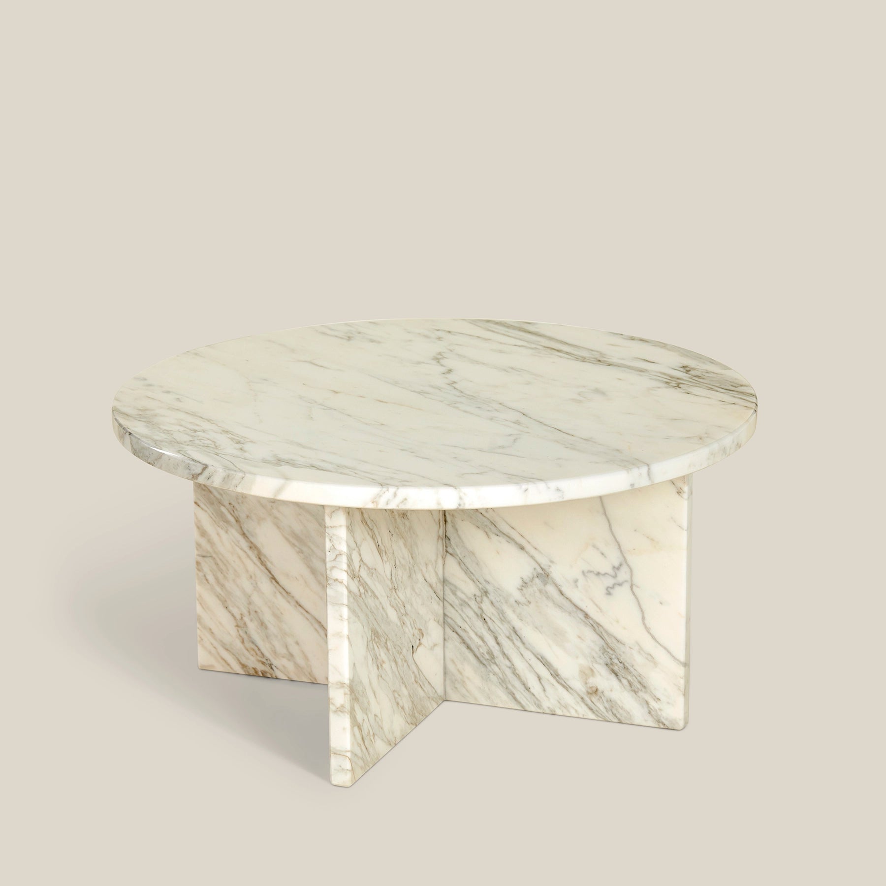 Leo – a minimalistic round coffee table made from white veined Calacatta marble.