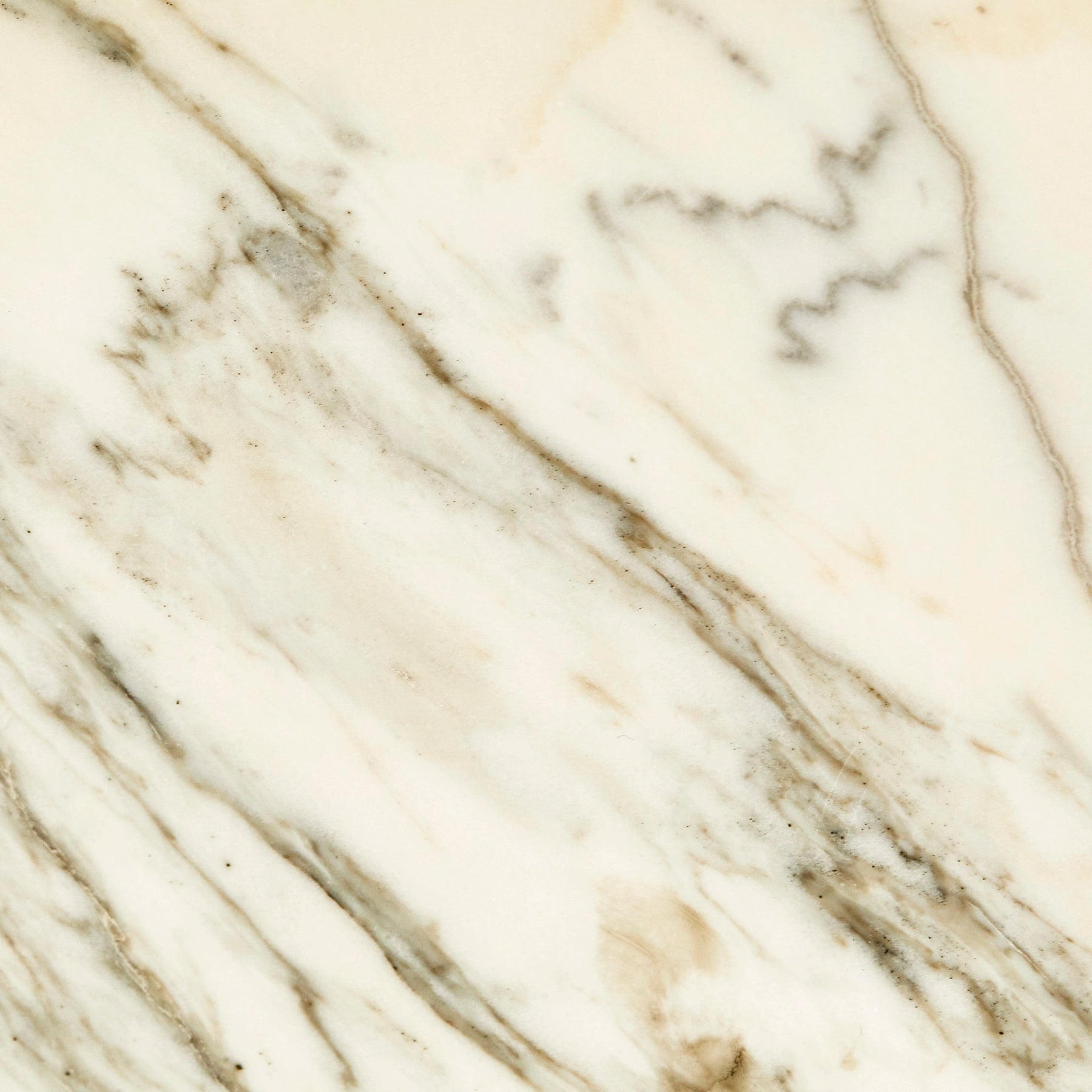 A close-up detail of white veined Calacatta marble.