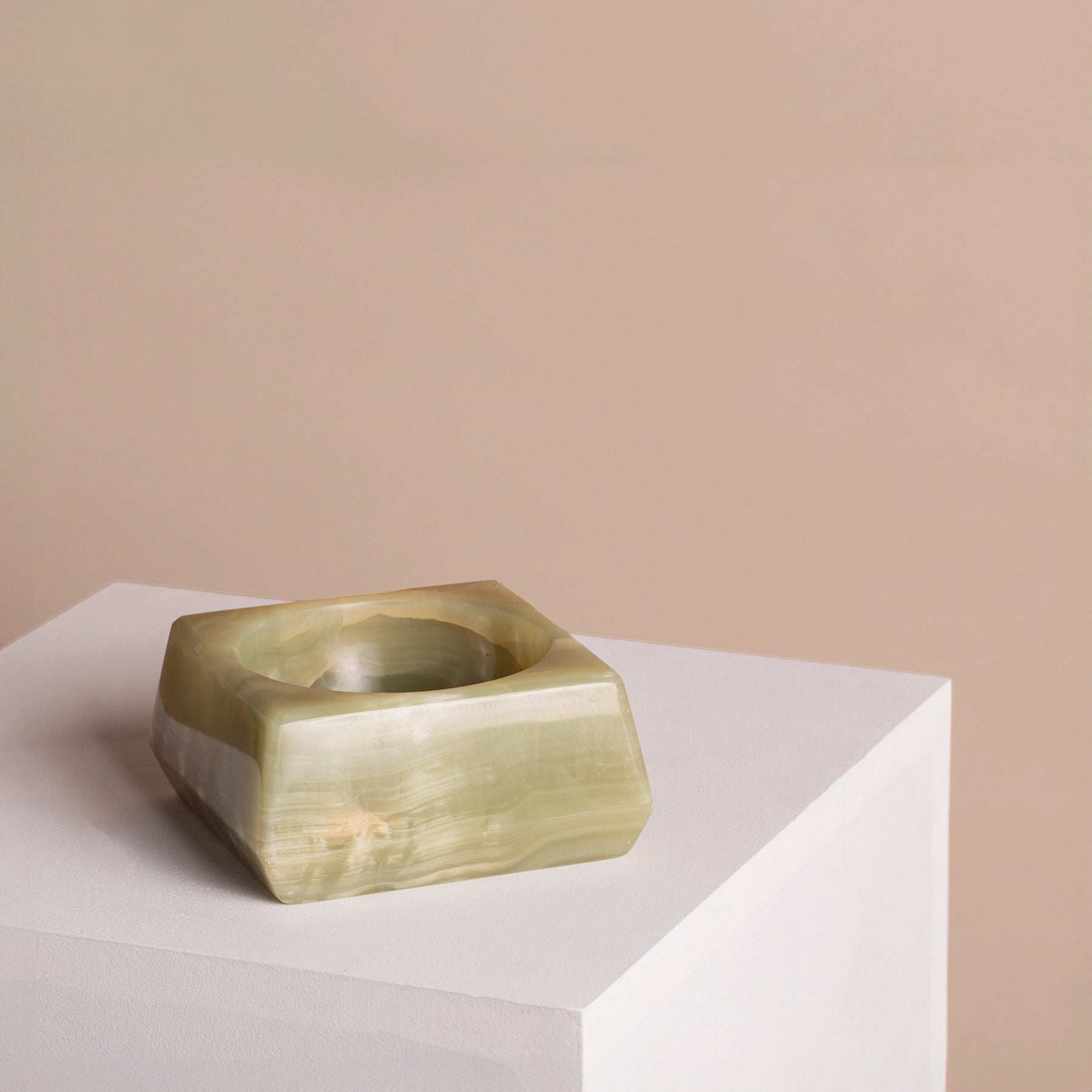 Green onyx jewellery holder on a plinth.