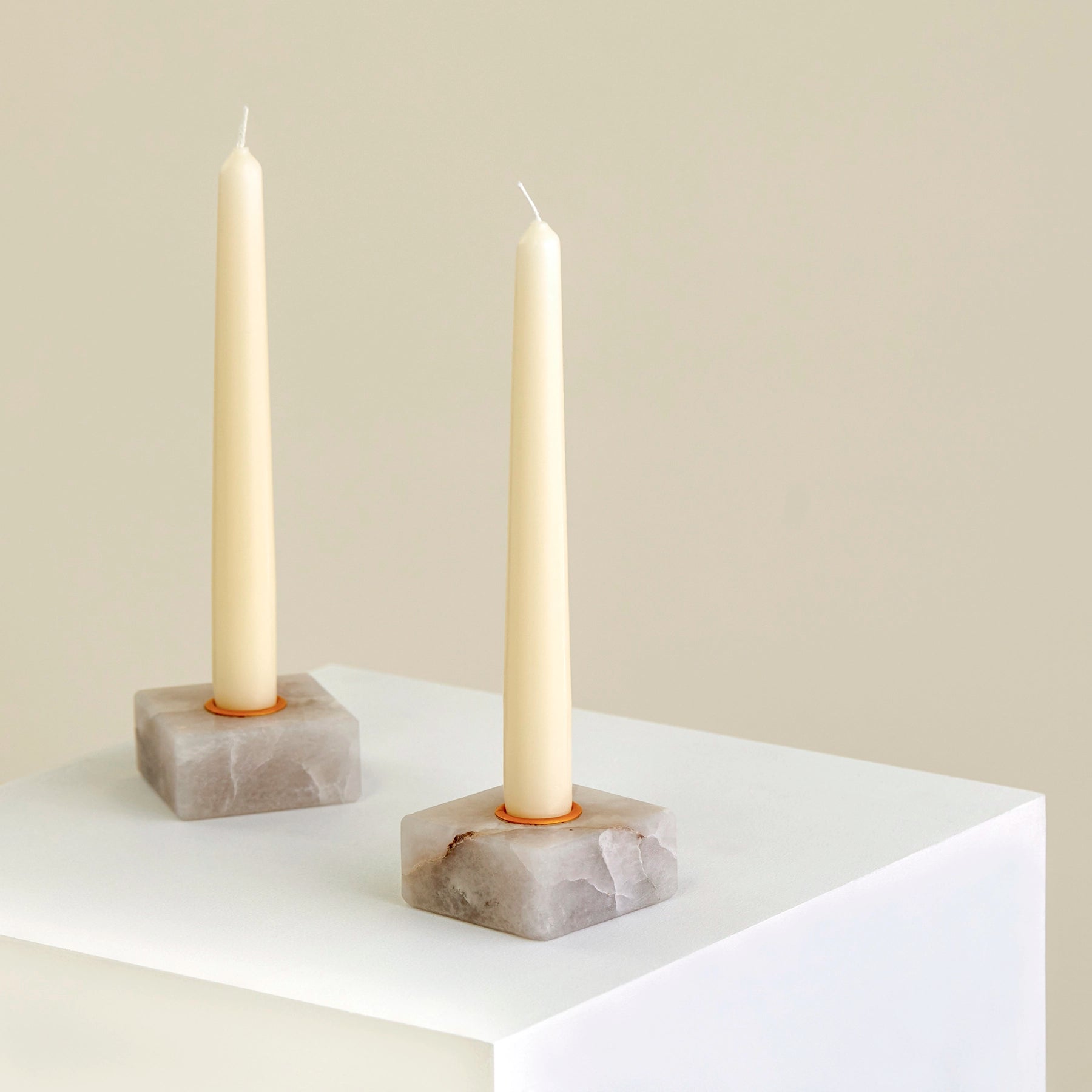 wo candle holders on a plinth made from Cristallo Imperial Onyx with gold detailing.