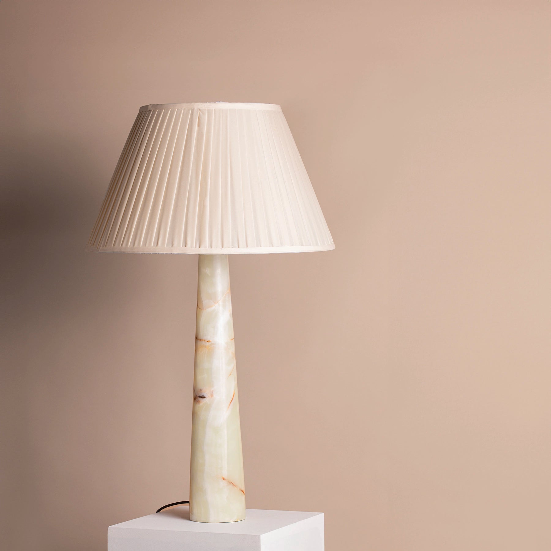 Large vintage pale green onyx, tapered table lamp on a plinth.