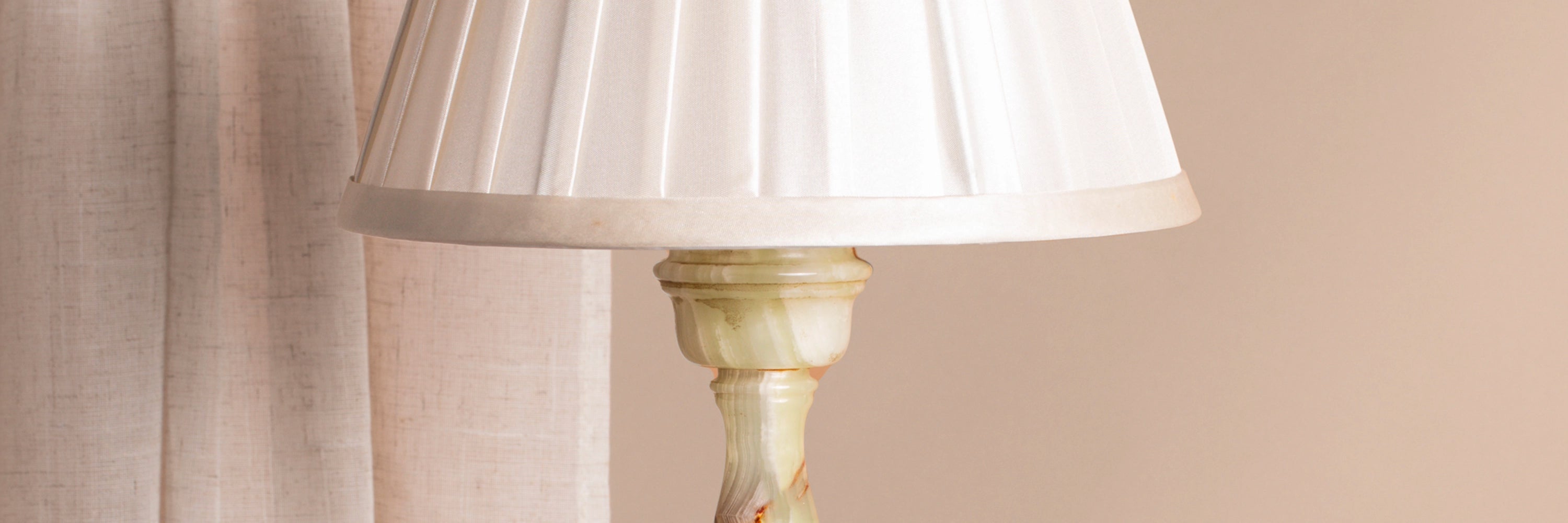 A close-up detail of vintage pale green onyx table lamp.